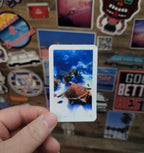 Hand holding a vinyl photo  sticker of a sea turtle taken while scuba diving in Key Largo Florida.