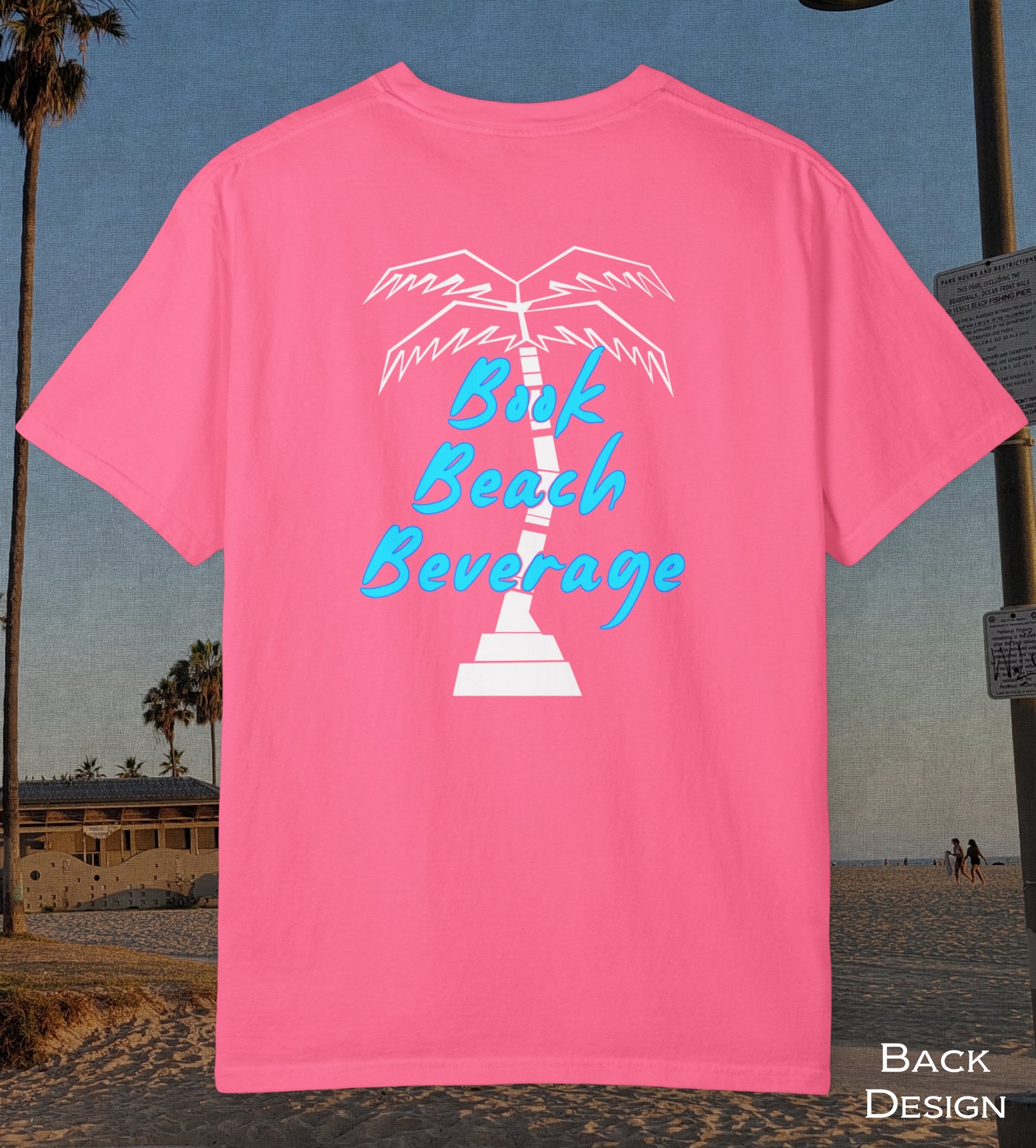 Comfort Colors cotton t-shirt Crunch Berry Pink in color featuring durable DTF back design of a white palm tree and the words Book Beach Beverage in blue.