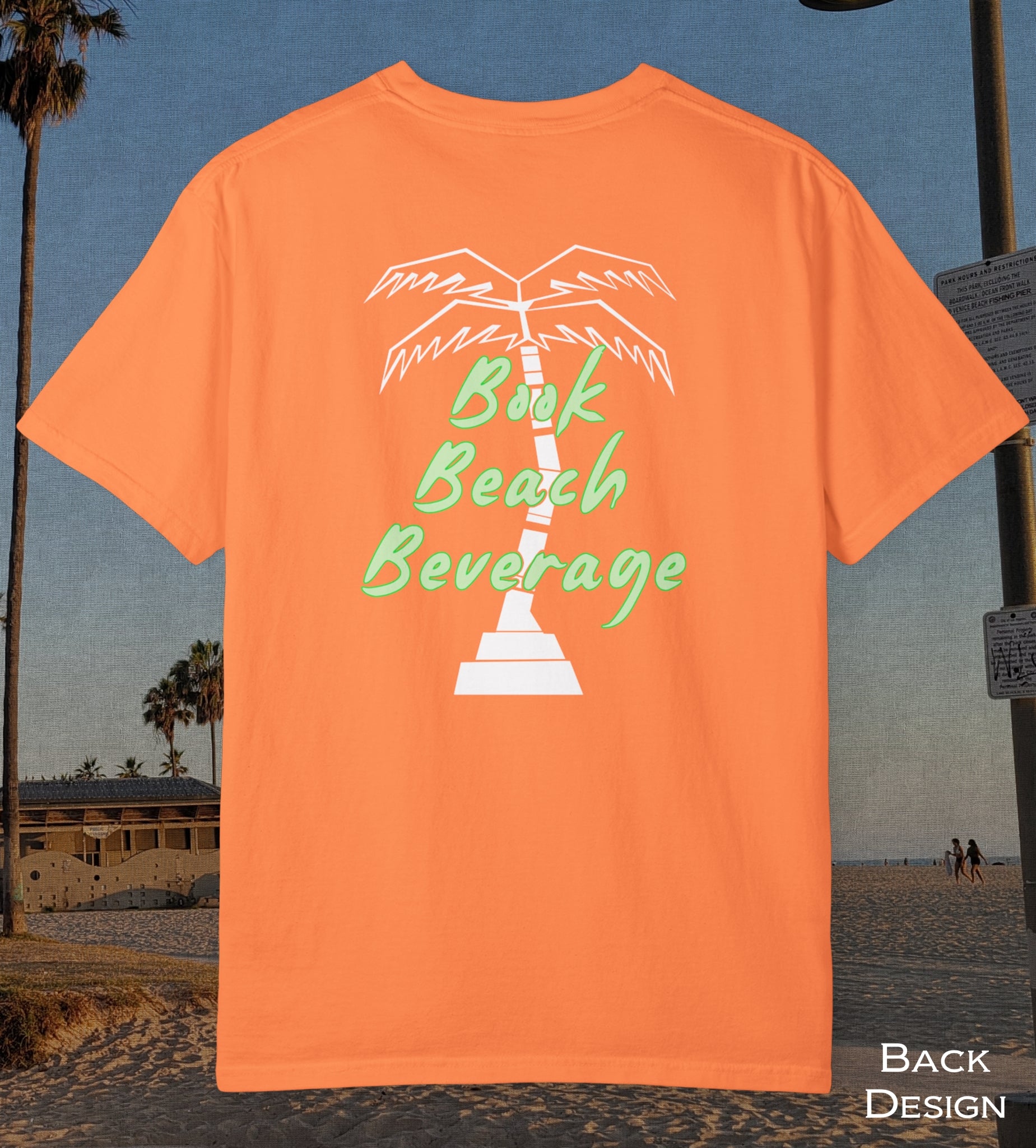 Comfort Colors cotton t-shirt Melon Orange in color featuring durable DTF back design of a white palm tree and the words Book Beach Beverage in light green.