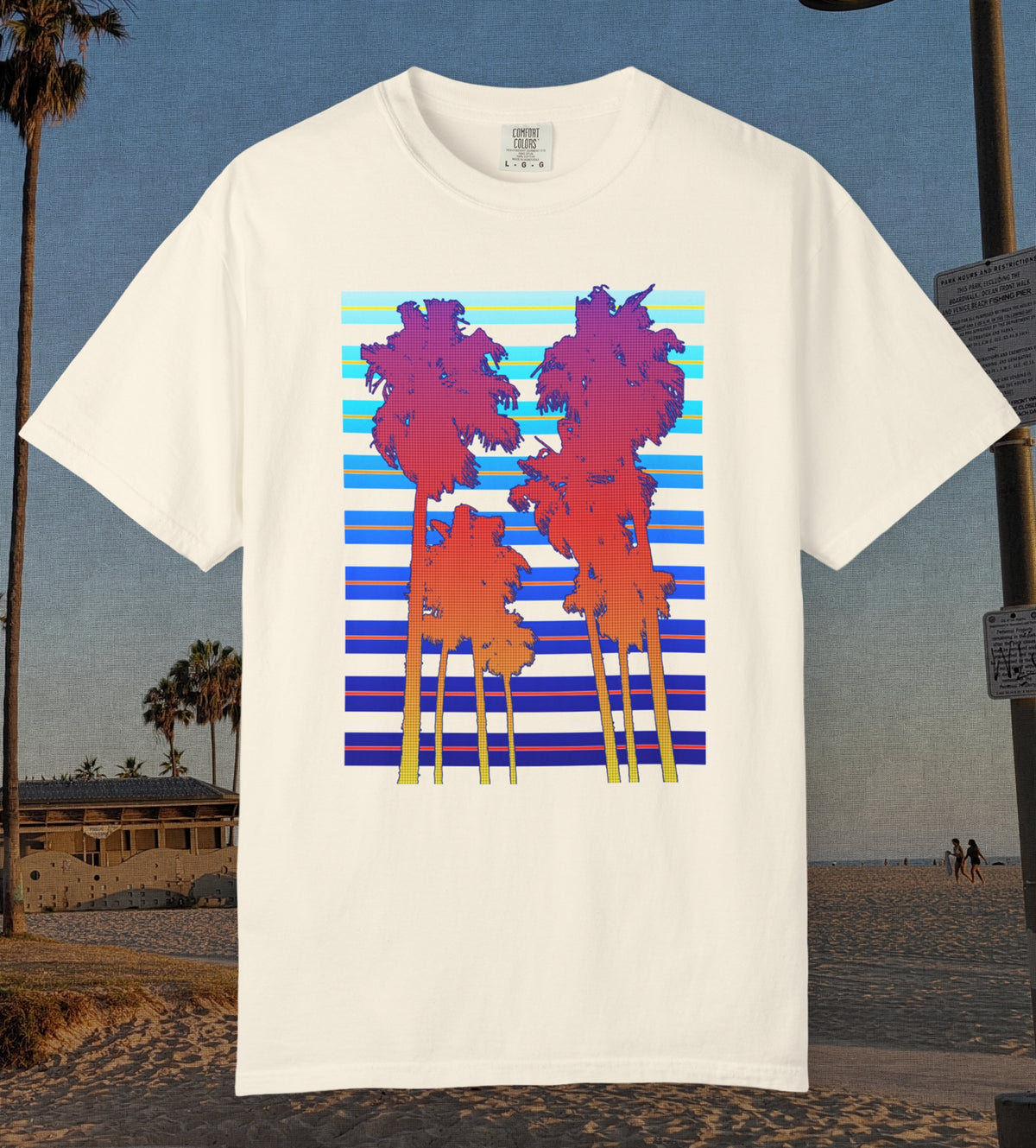 Comfort Colors cotton t-shirt Ivory in color featuring a DTF graphic of palm tree silhouettes in warm colors with a cool color background pattern.