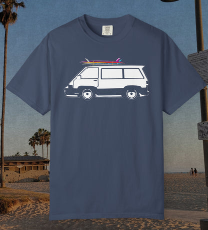 A navy blue short-sleeve t-shirt featuring a graphic of a white van with pink and red surfboards on its roof, set against a beach background.
