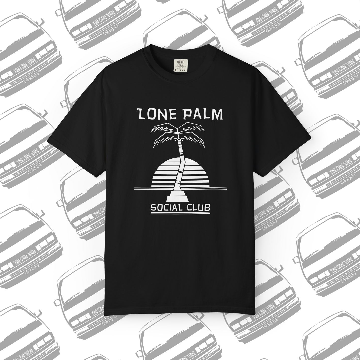 Black Comfort Colors graphic t-shirt with DTF  'Lone Palm Social Club' palm tree graphic on a background with van silhouettes.