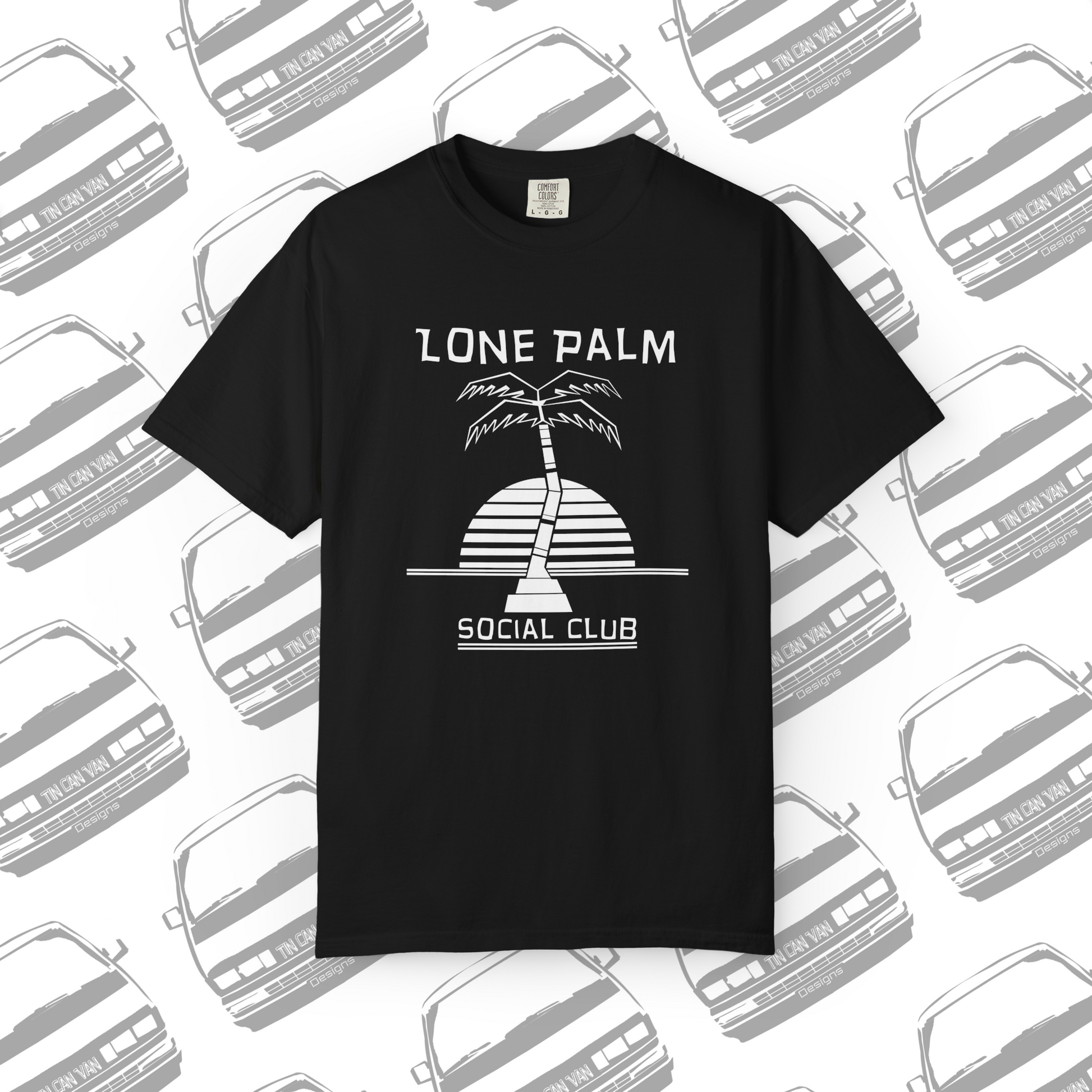 Black Comfort Colors graphic t-shirt with DTF  'Lone Palm Social Club' palm tree graphic on a background with van silhouettes.