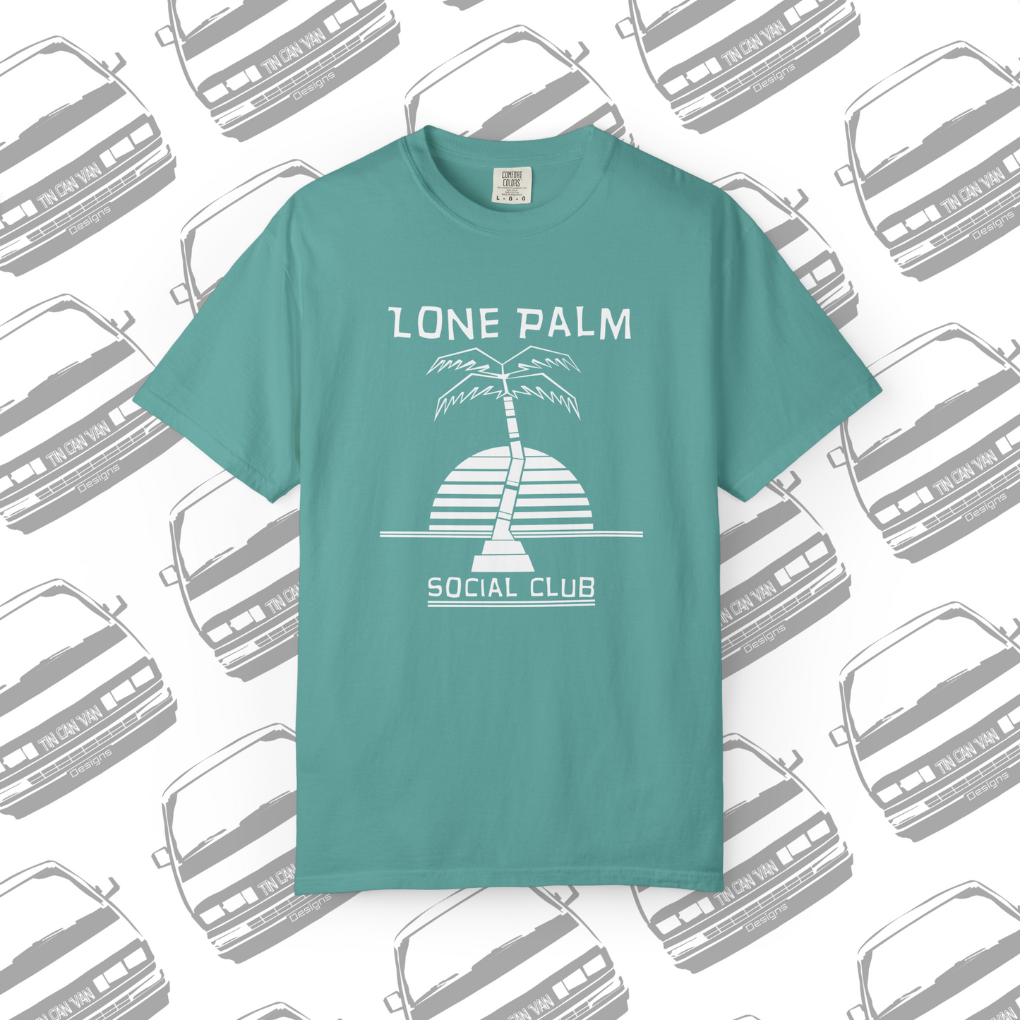 Sea foam green teal Comfort Colors graphic t-shirt with DTF  'Lone Palm Social Club' palm tree graphic on a background with van silhouettes.