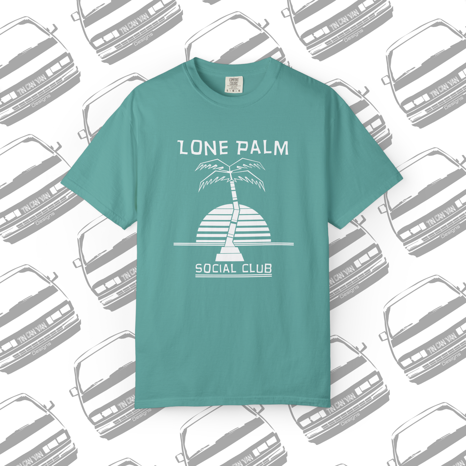 Sea foam green teal Comfort Colors graphic t-shirt with DTF  'Lone Palm Social Club' palm tree graphic on a background with van silhouettes.